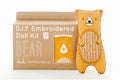 D.I.Y. Embroidered Doll Kit with a bear design on a cardboard box.